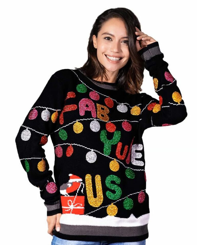 A grinning woman rocks the over-the-top Fab-Yule-Ous sweater—glitter lights, "FAB-YULE-US" flair, Santa hats, gifts, party chaos!.