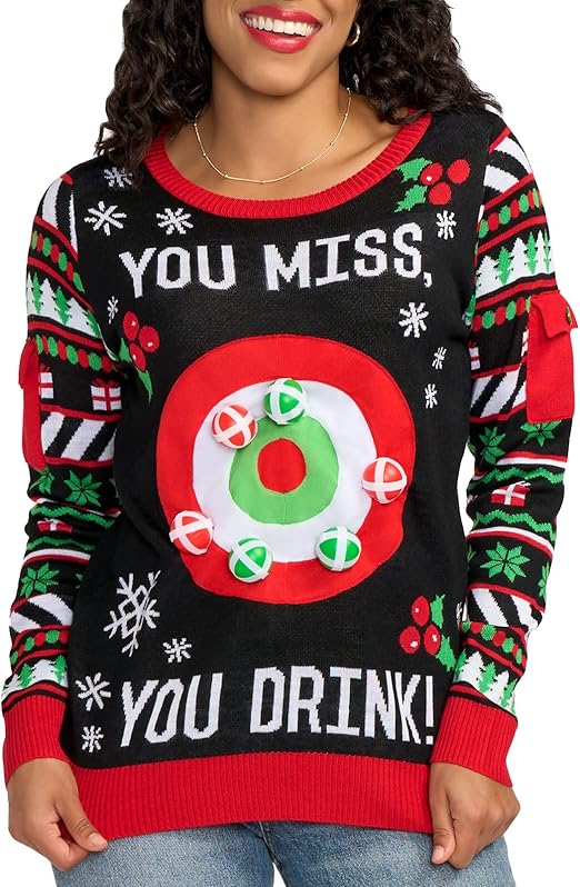 A woman rocks the wild “You Miss You Drink” sweater—bullseye target, cheesy festivity, and a drinking dare. Party MVP alert!.