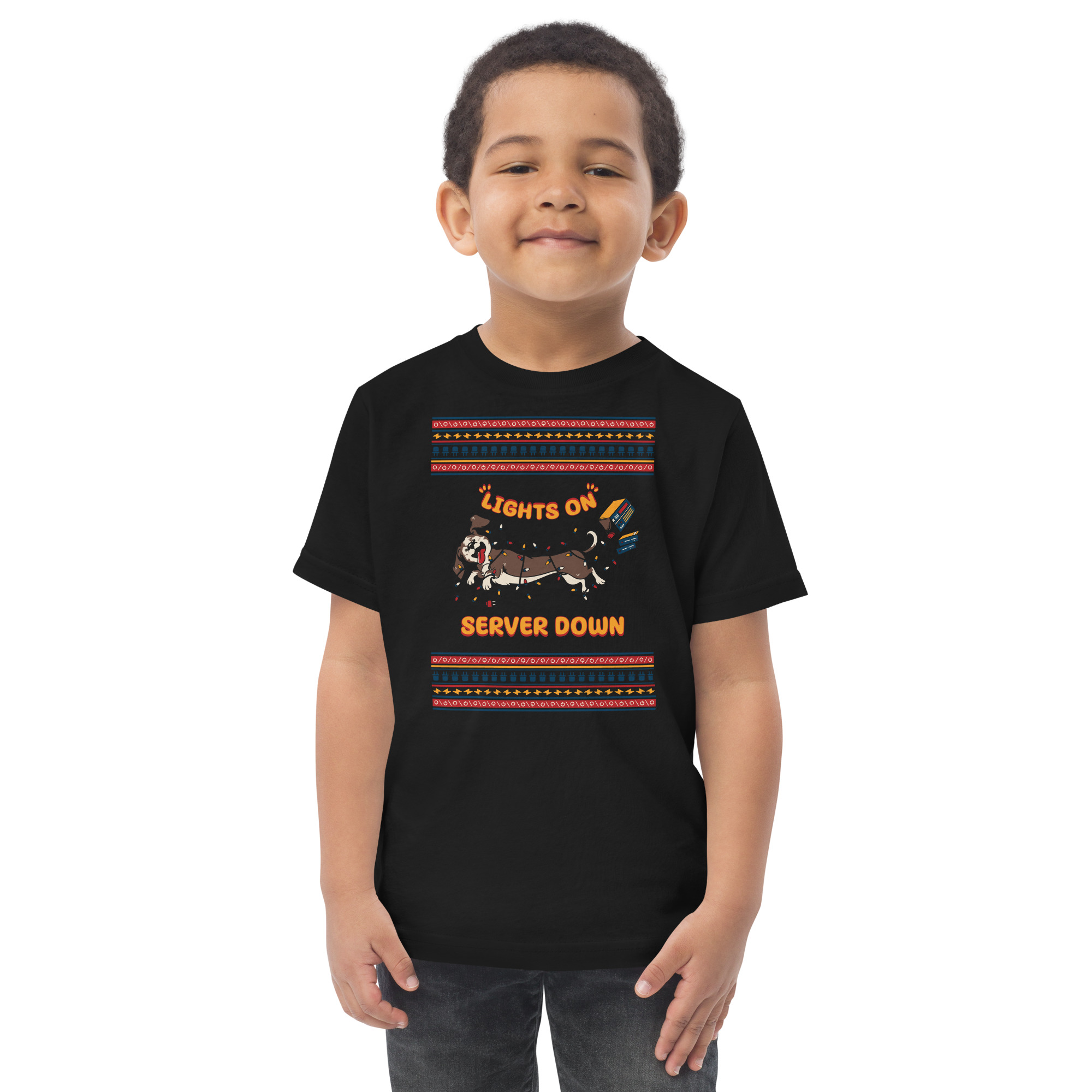 Grinning kid in a holiday tee—dachshund tangled in lights, “Lights On, Server Down.” Because servers crash harder at parties!.