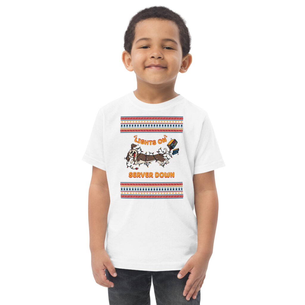 Grinning kid rocks a tee showing chaos: pups wrapped in twinkly lights, with “Lights On! Server Down”. Party disaster vibes!
