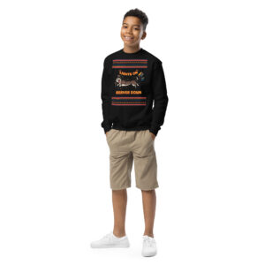 Meet Mr. Too-Cool-for-Yule: grinning boy, hands in pockets, black crewneck, tan shorts, white kicks—party-ready on plain white!.