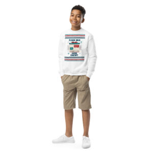 Get a load of this party pro: grinning kid rocking a wild white crewneck with splashes of color, beige shorts, and fresh kicks—move over fashionistas!.