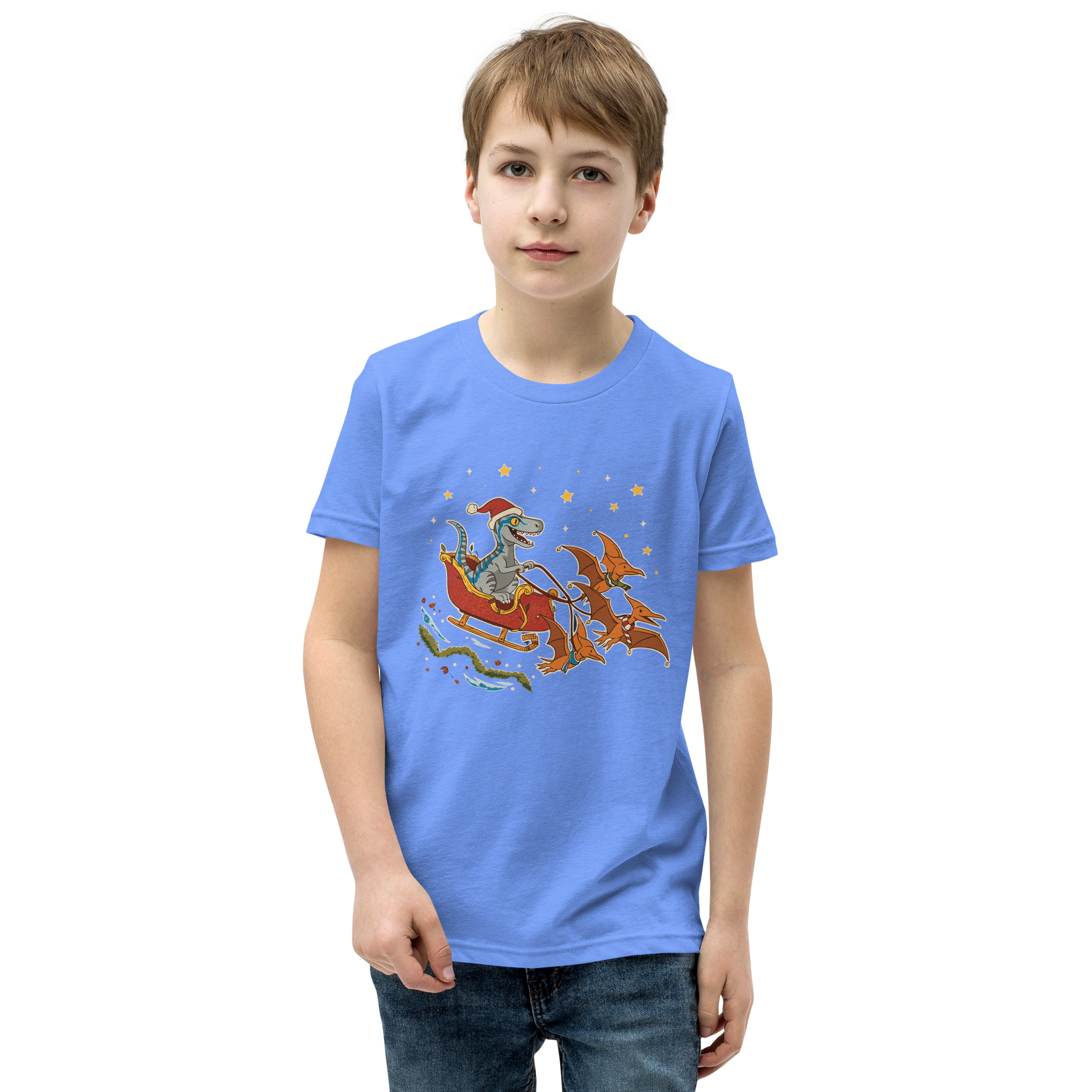 A boy rocks a straight face in a light blue tee—Santa rides dinos through the stars, because reindeer are so last season.