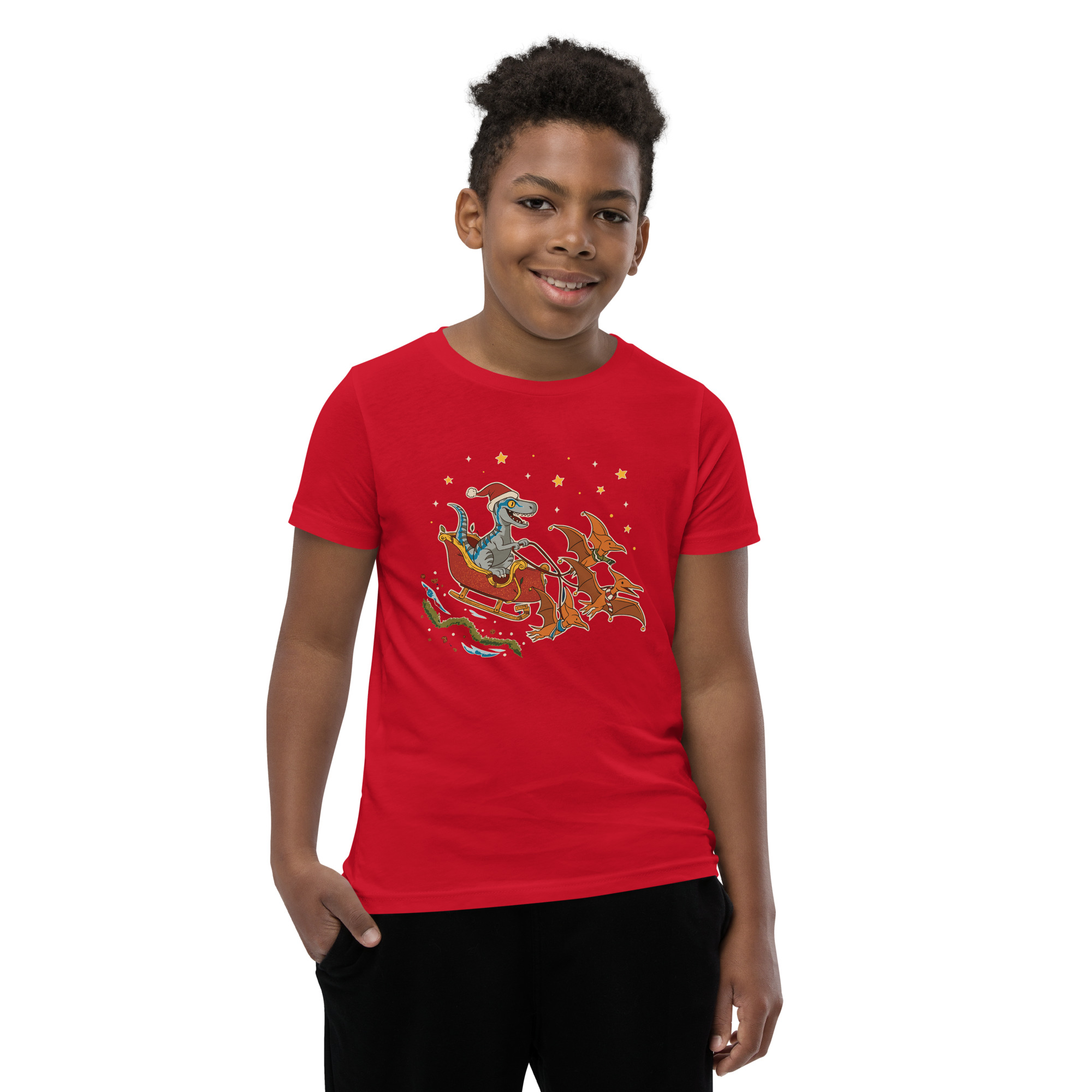 A grinning boy rocks a red tee decked out with Santa and reindeer—one hand pocketed, 100% ready to win any ridiculous holiday bash.